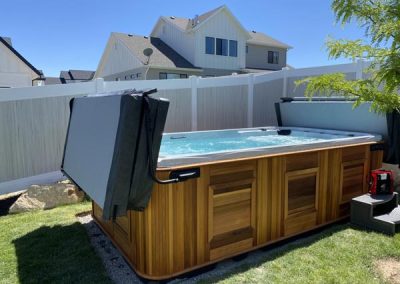 uncovered all weather pool arctic spas in red cedar cabinet in the backyard